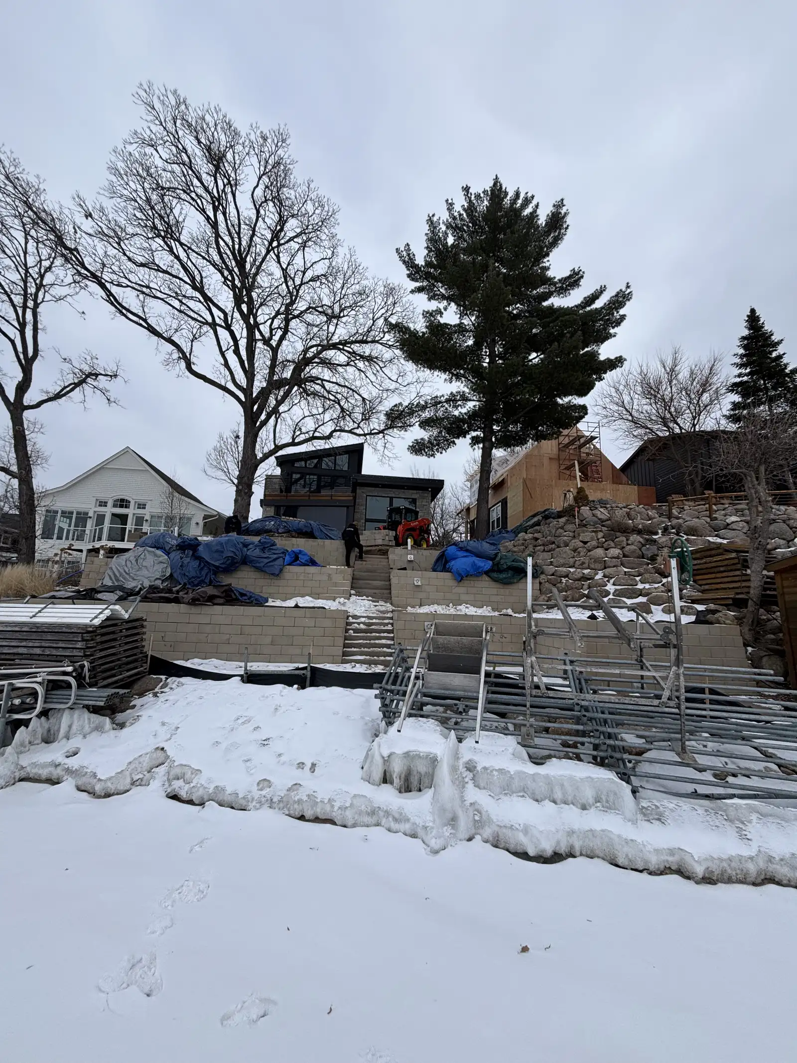 Three-tier retaining wall system with OUTDECO privacy panels and 50+ outdoor lights in Excelsior, MN