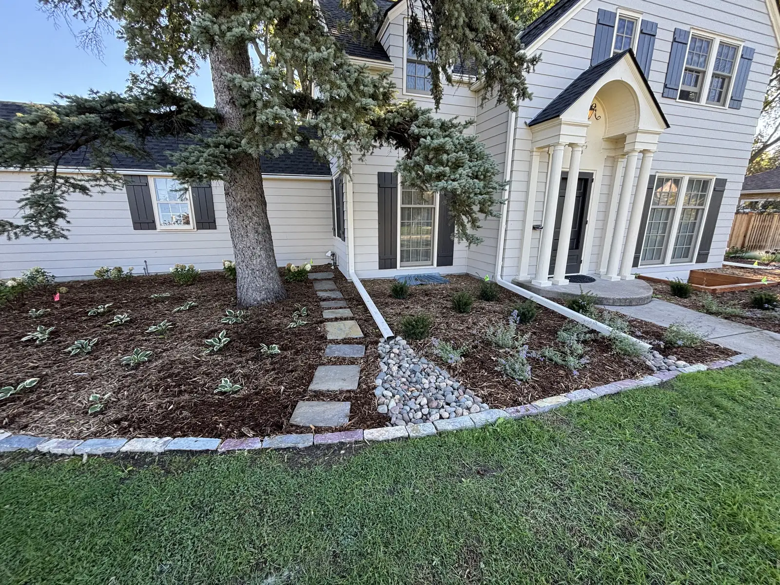 Natural stone slab steps set into a hillside with boulder sidewalls