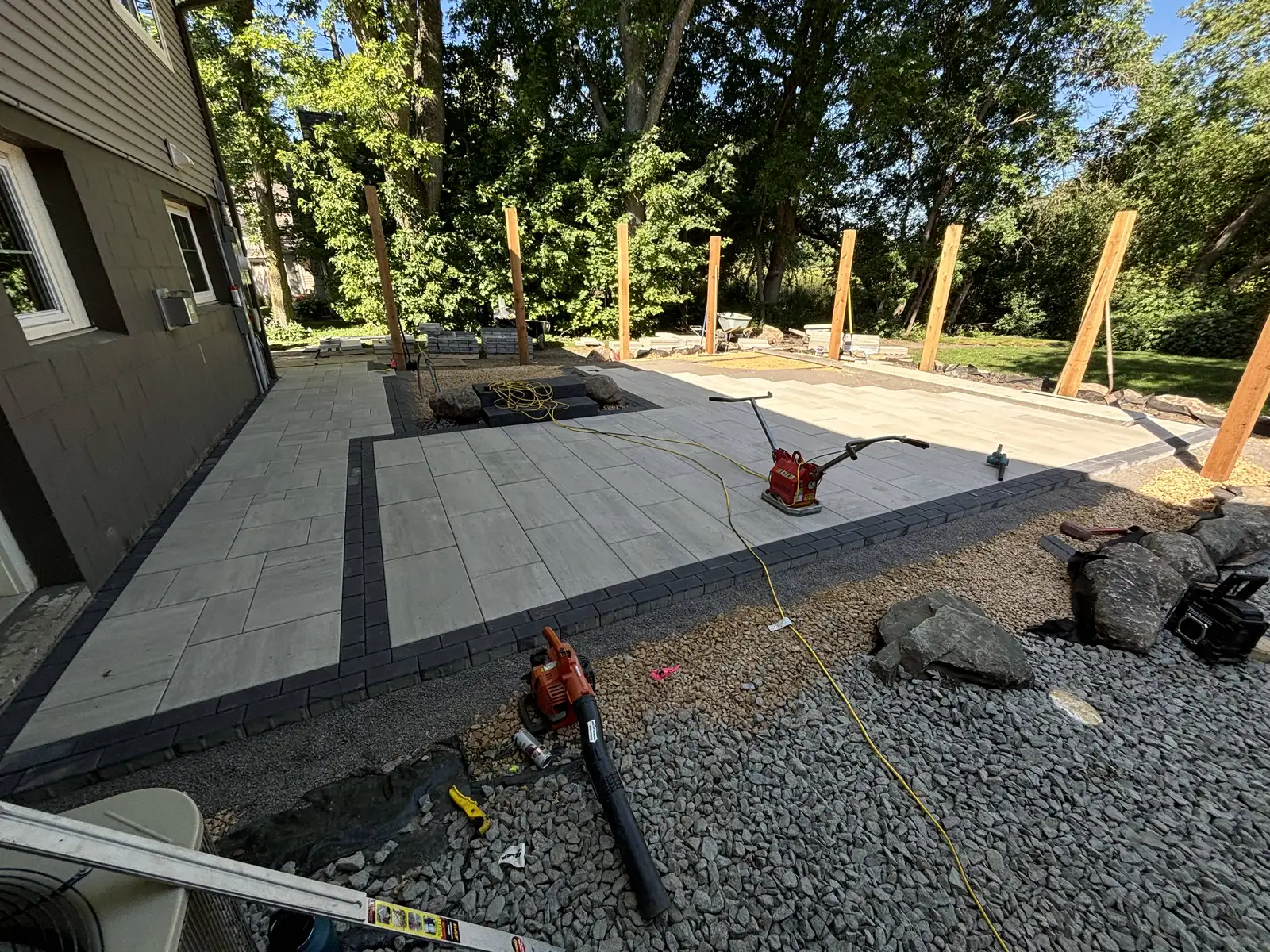 Stone privacy wall with integrated planting pockets and cap stones