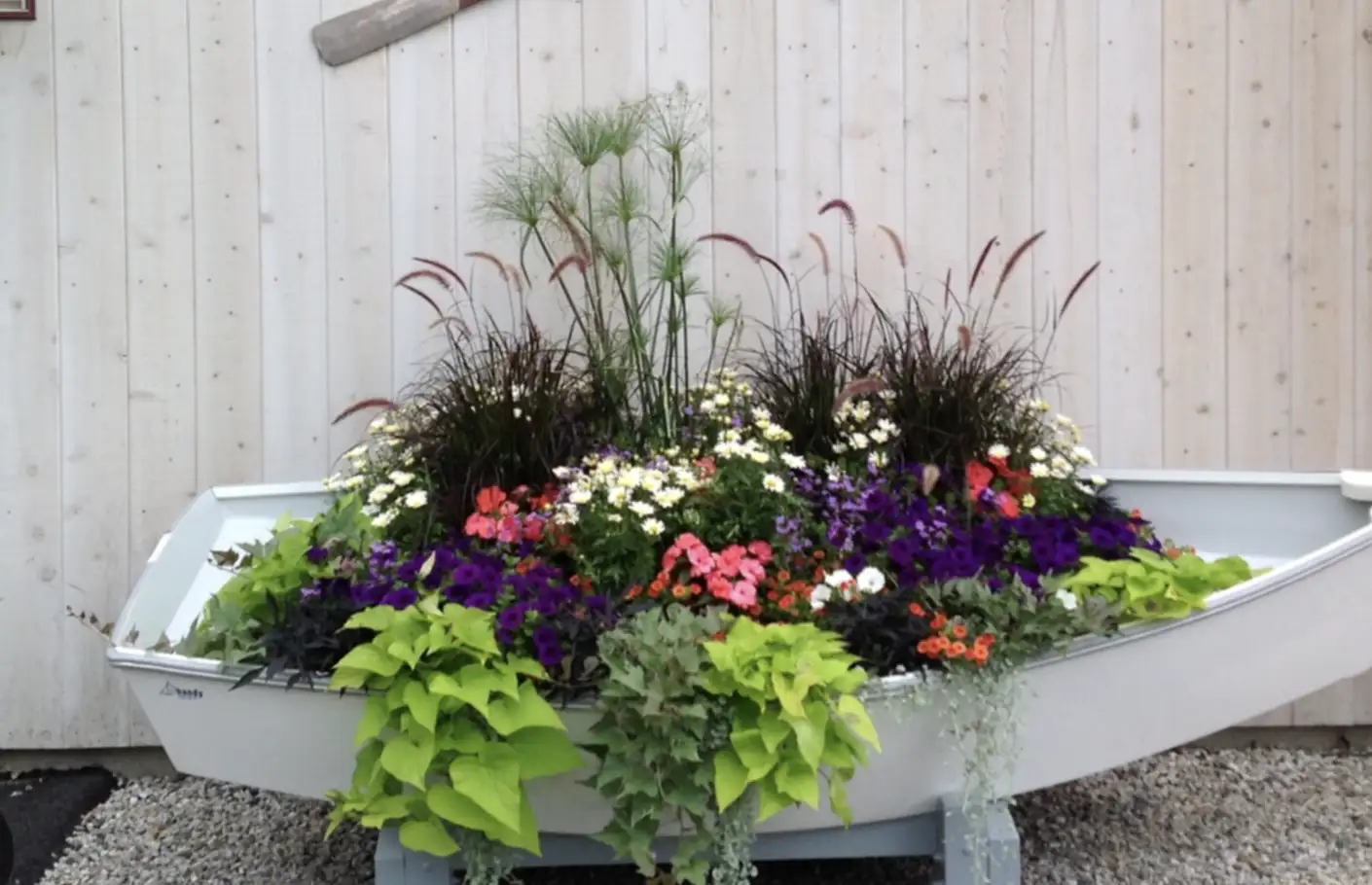Colorful ornamental plantings with hydrangeas, hostas, and decorative grasses at residential entrance