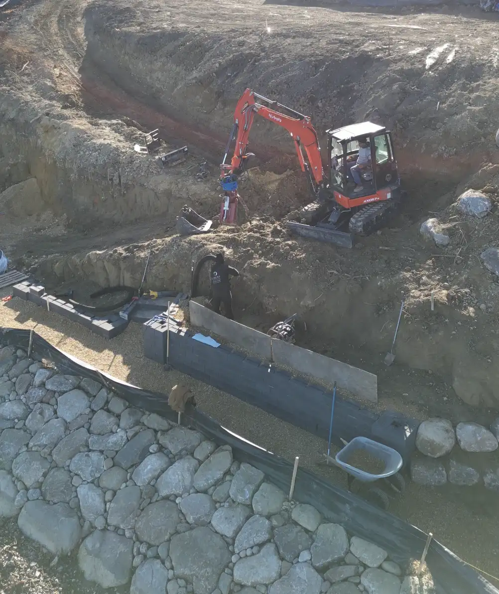 Kubota excavator performing finish grading on a residential lot in Shorewood