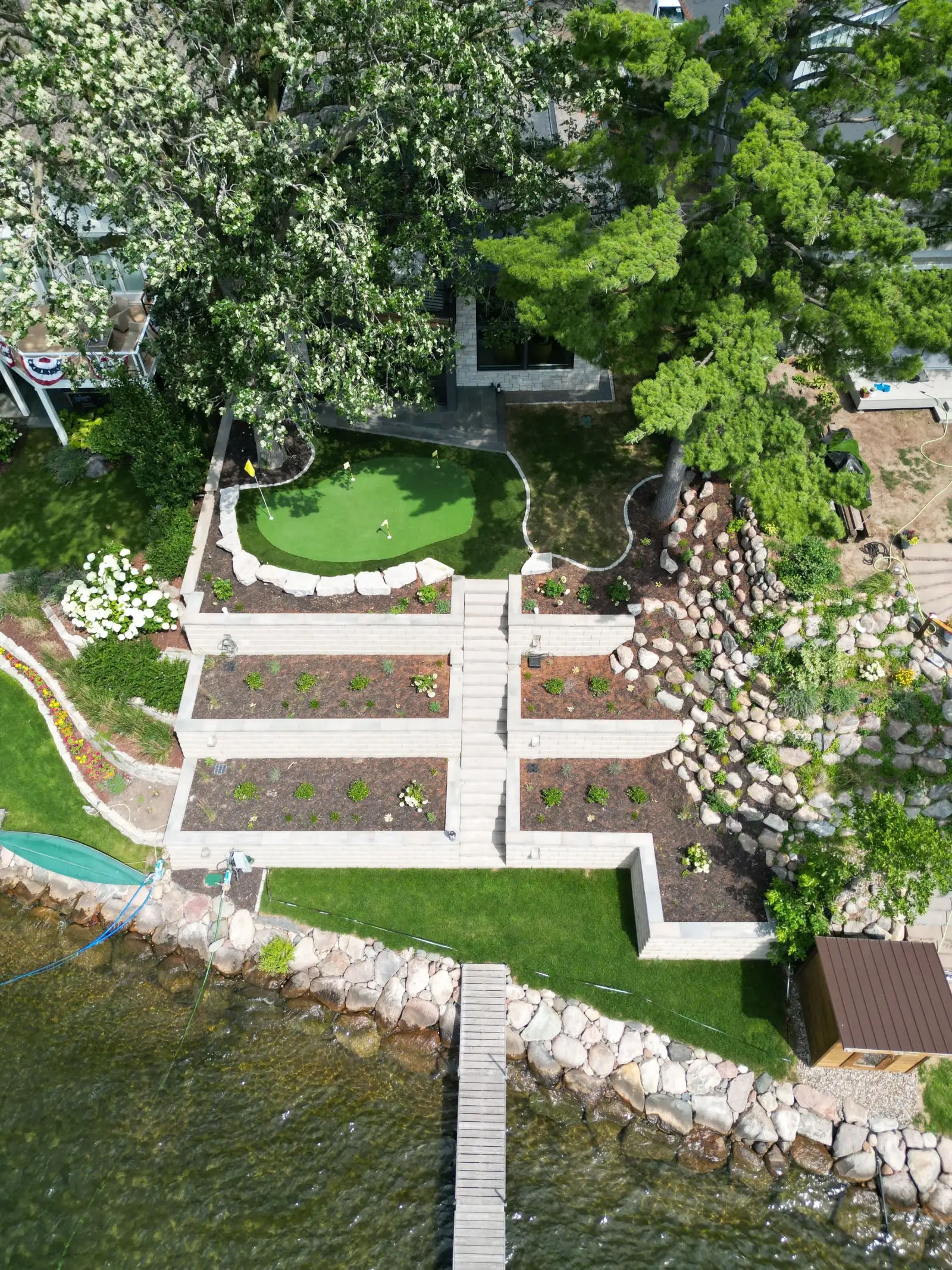 Aerial drone view of a completed landscape project by Lifecycle Outdoor Services on Lake Minnetonka