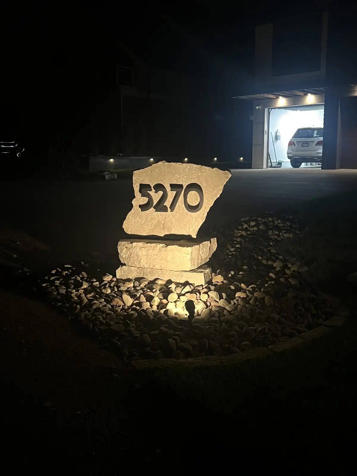 Outdoor LED lighting illuminating landscape features and plantings at night