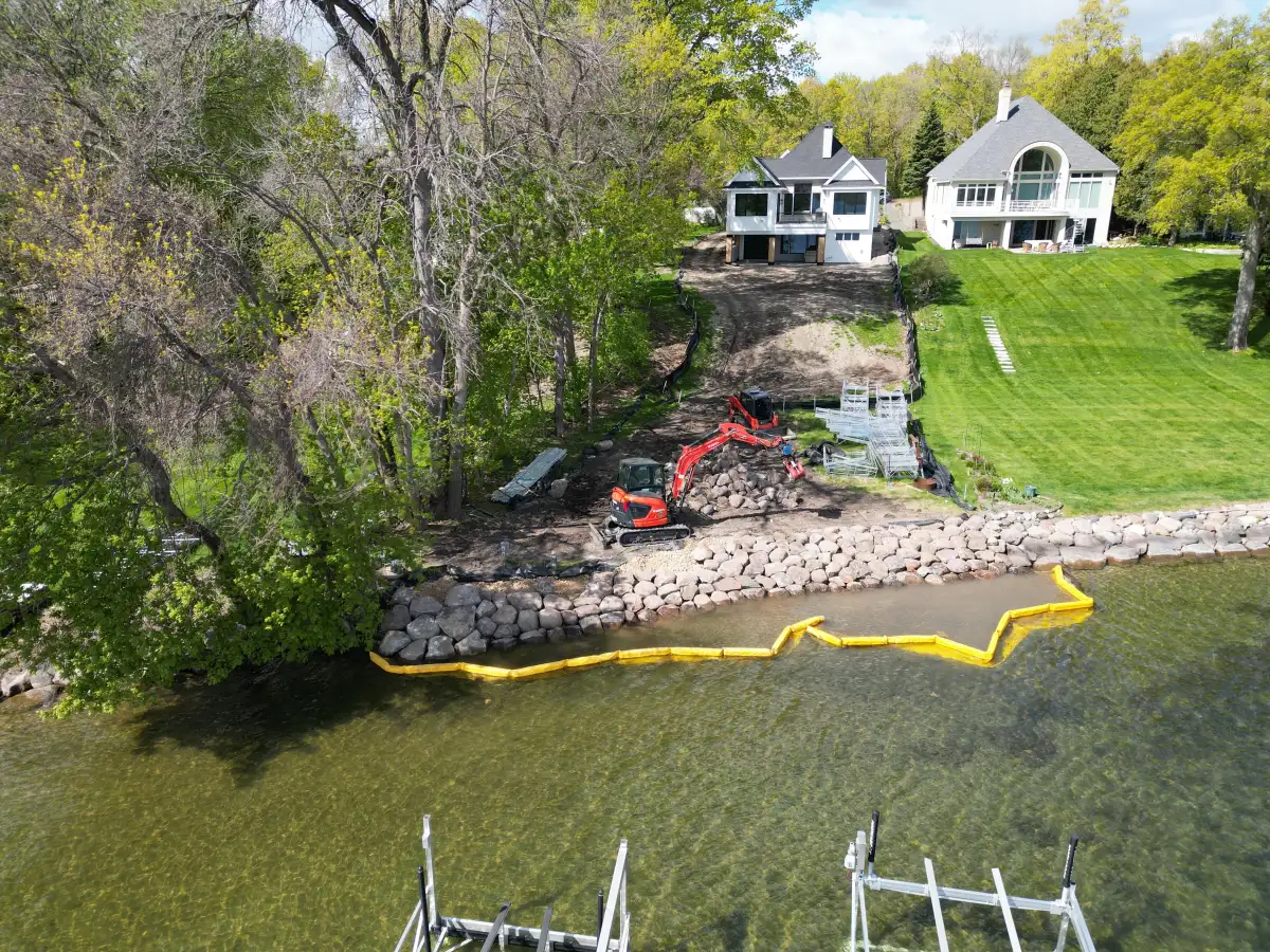 Aerial view of Lake Minnetonka shoreline rip rap project in Orono showing luxury home and boulder placement