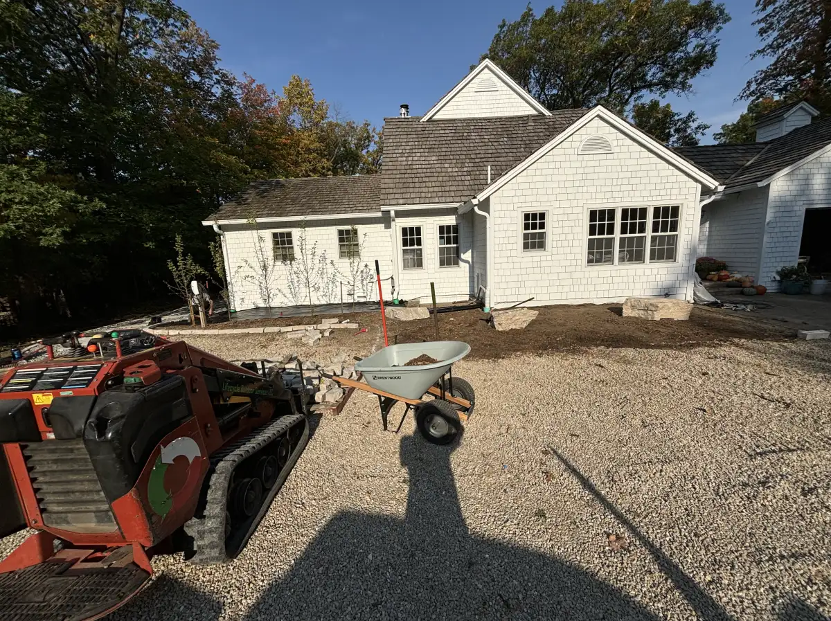 Landscape refresh in progress — skid steer and gravel base preparation at lakefront property in Orono, MN