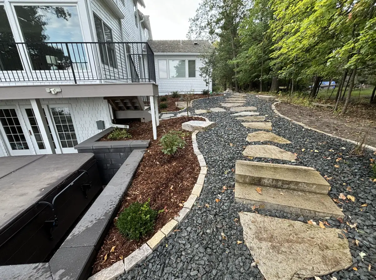 Completed landscape refresh with natural stone stepping path, trap rock, and Fond du Lac edging on Lake Minnetonka in Orono, MN