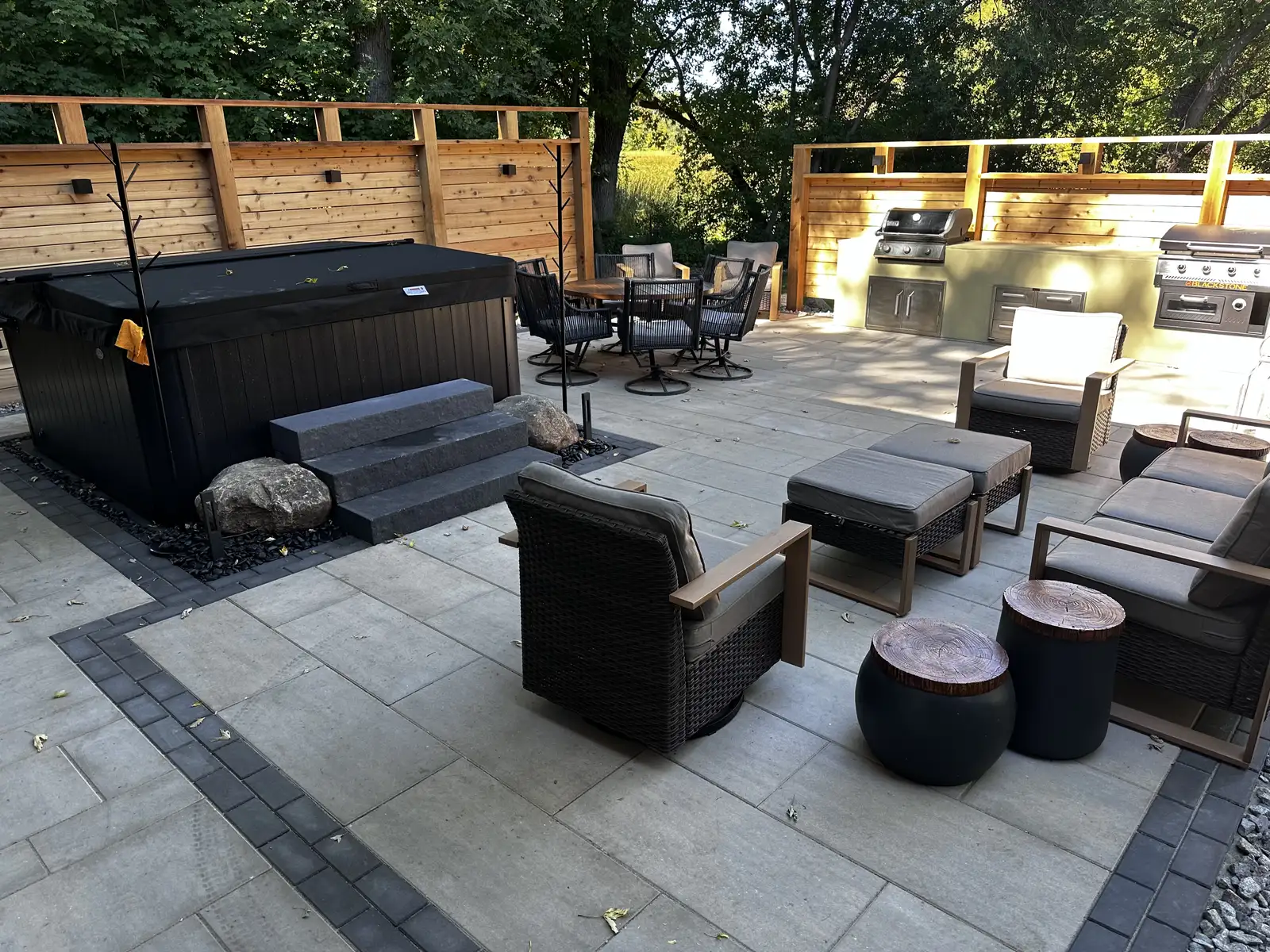 Complete outdoor living transformation with paver patio, outdoor kitchen, and hot tub in Waconia, MN